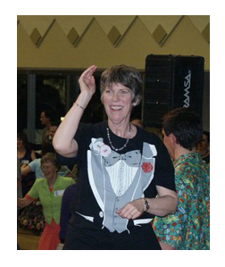 Sue conducting at the 2005 Megaband dance, with Erik Weberg, caller, behind her.